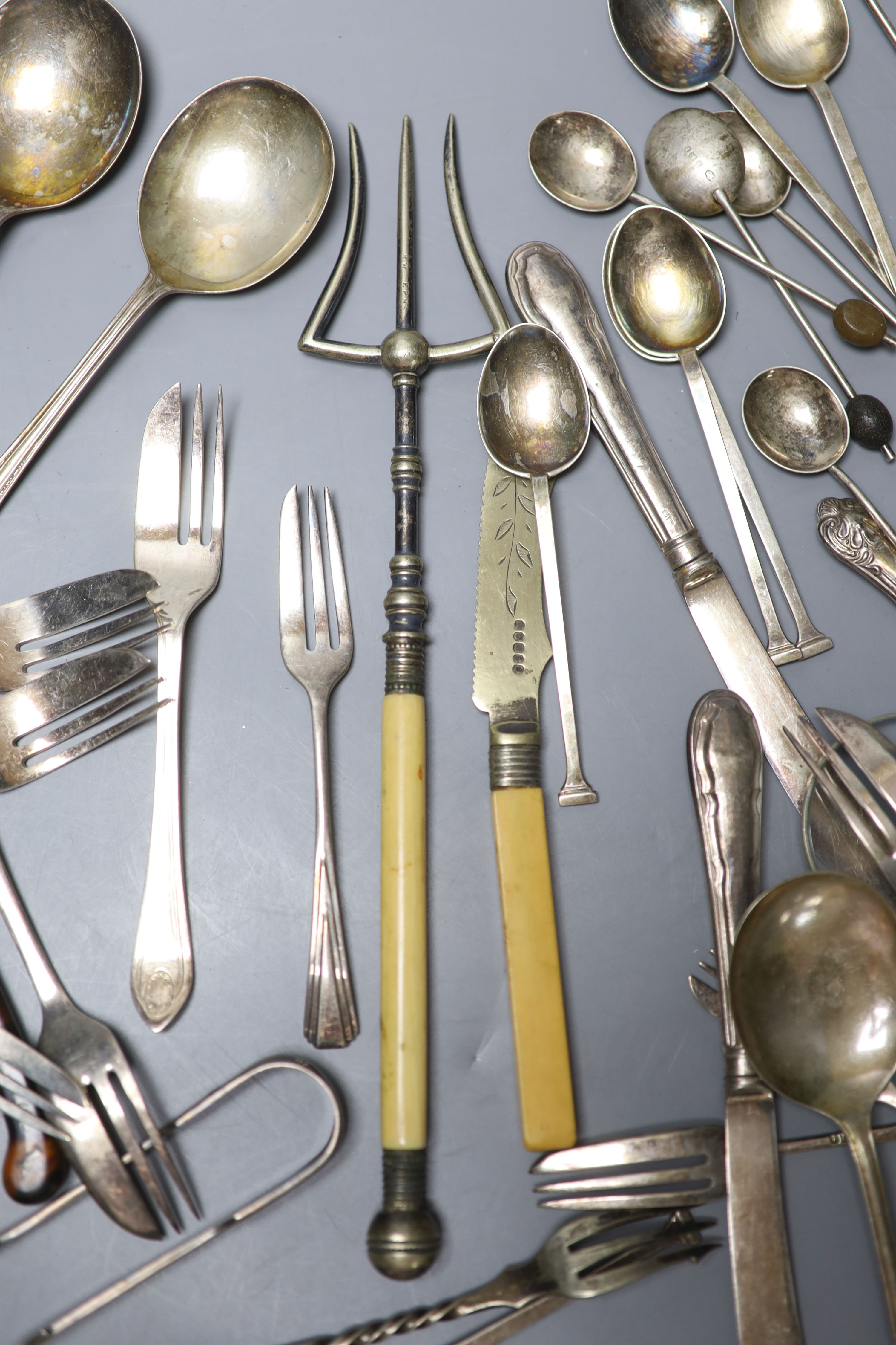 Two sets of silver spoons including bean end coffee spoons, six silver handled tea knives and a silver handled magnifyer etc.